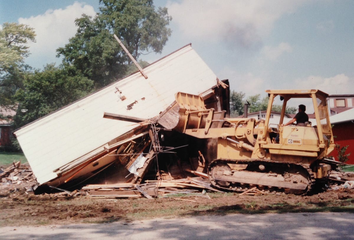 032 Bulldozer demolishing a collapsed white house