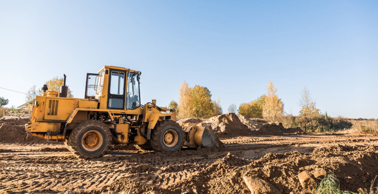 Yellow bulldozer at work on construction site